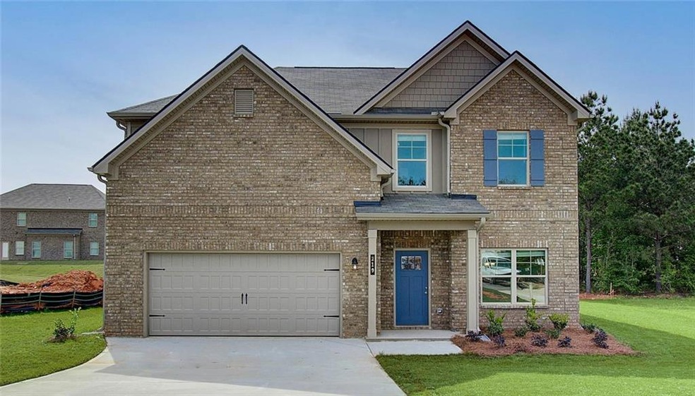 Craftsman inspired home with a front lawn and a ga