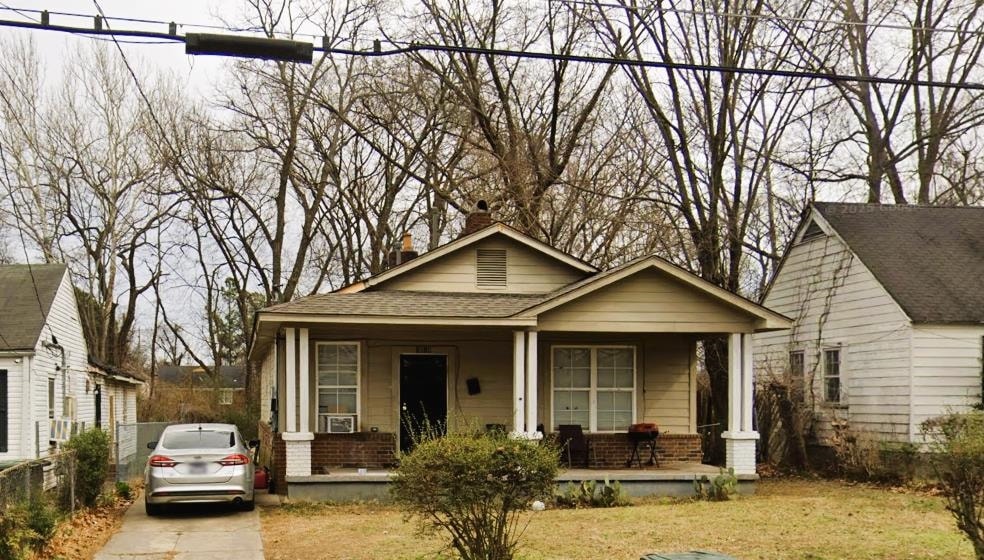 Bungalow-style home with concrete driveway, a chim