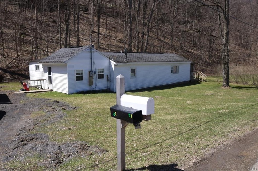 front of home showing woods in back