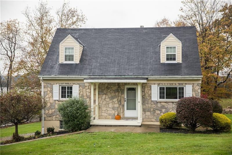 CHARMING STONE TWO STORY CAPE COD ON ONE ACRE LOT.