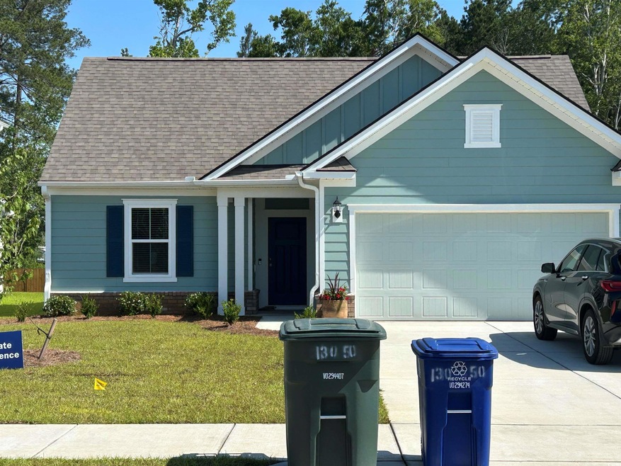 View of front of house with concrete driveway, boa