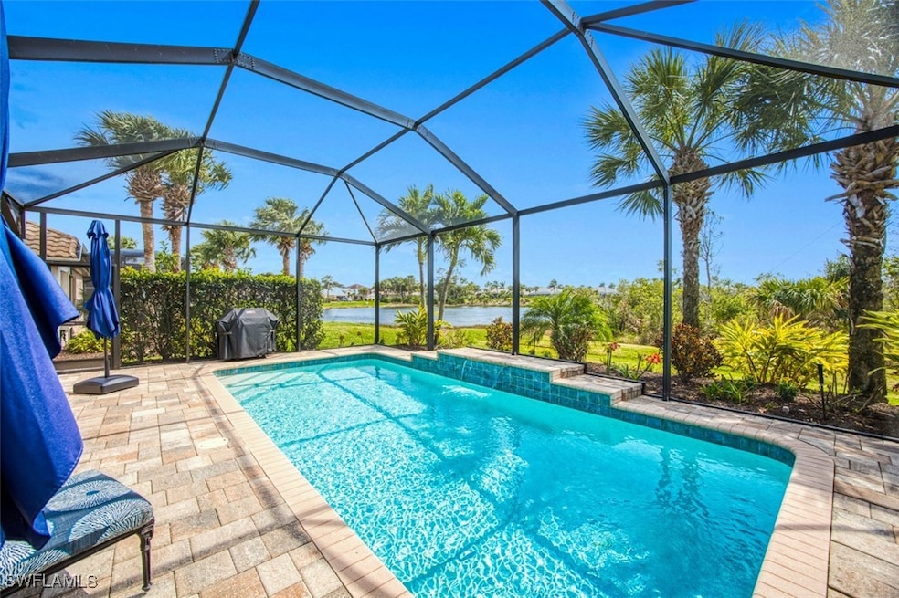 Pool featuring glass enclosure, a patio area, a wa