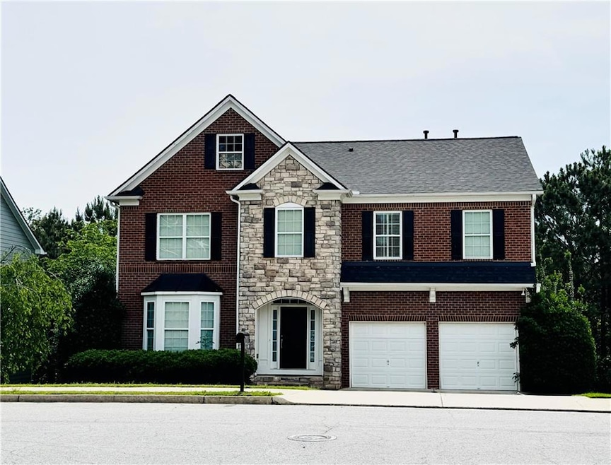 View of front facade featuring stone siding, an at