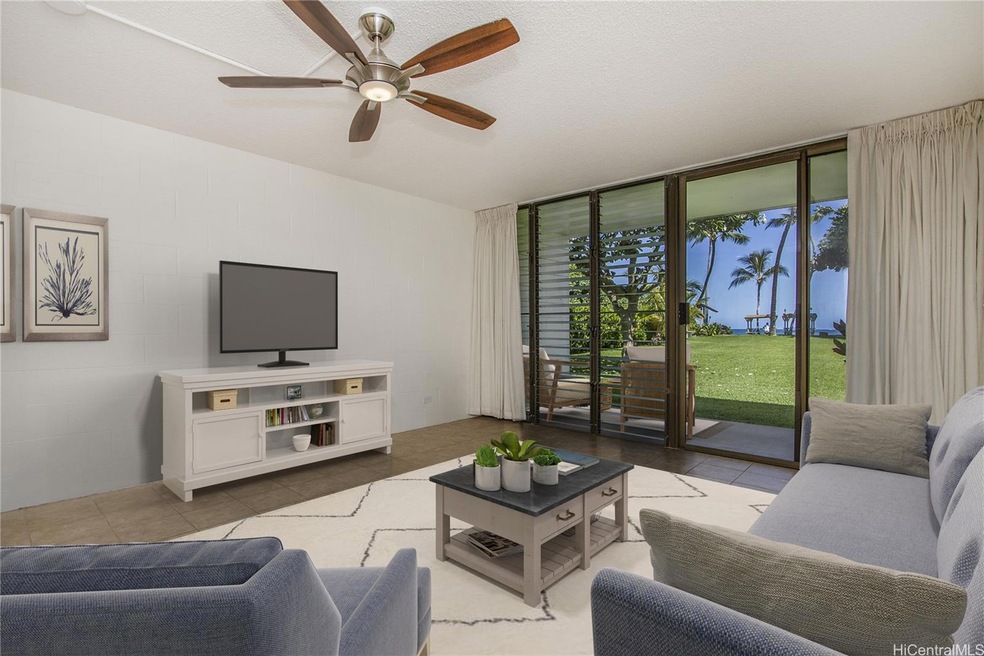 Virtually staged living room with view of the ocea
