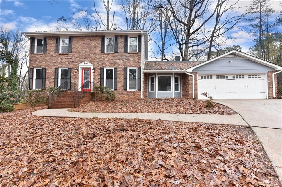 Note the Carriage Garage door, large driveway with