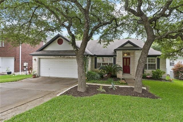 Breathtaking curb appeal with its large shady tree