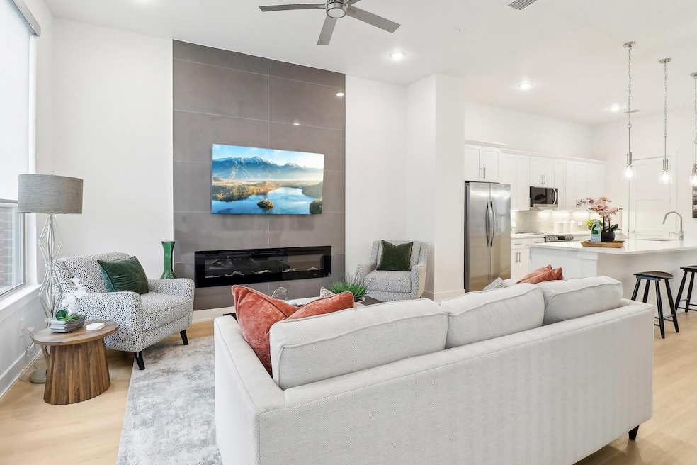 Living area featuring light wood-style floors, a l