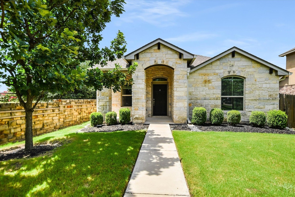 French country inspired facade with stone siding 