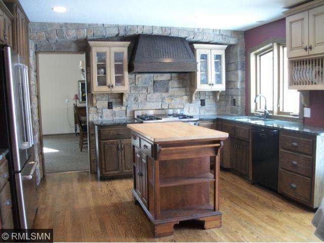 Your updated kitchen features granite, Wolf gas ra