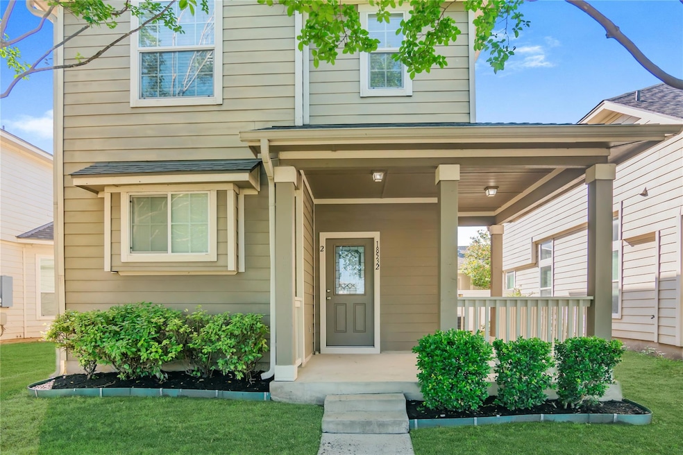 Doorway to property with a lawn and a porch