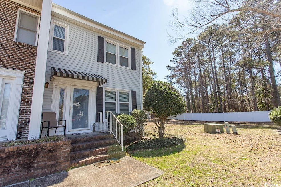 View of front of home with fence and a front lawn