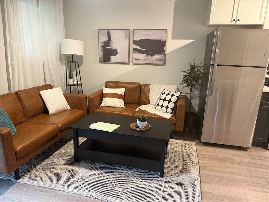 Living area with light wood finished floors