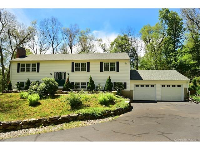 Stately 4BR, 3BA raised ranch which sits privately