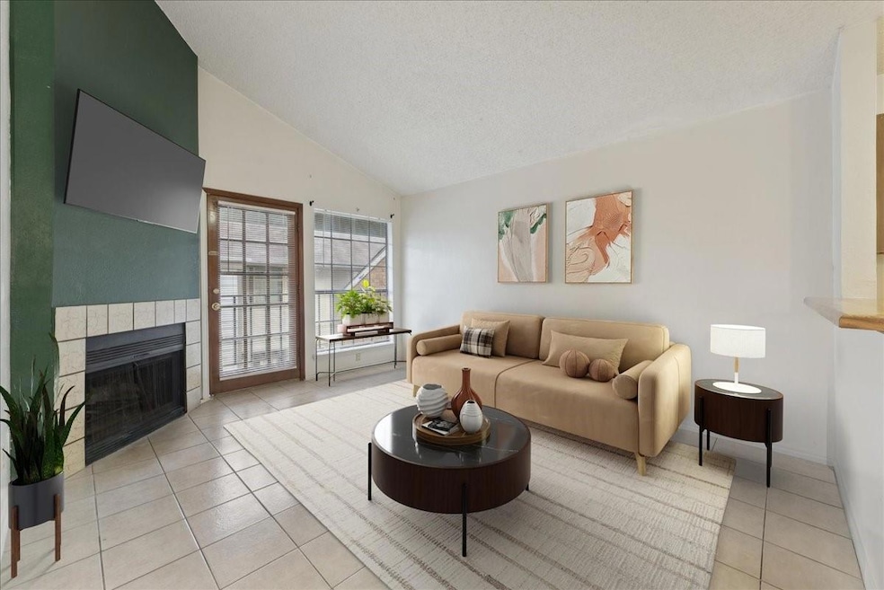 Living room featuring a textured ceiling, a tiled 