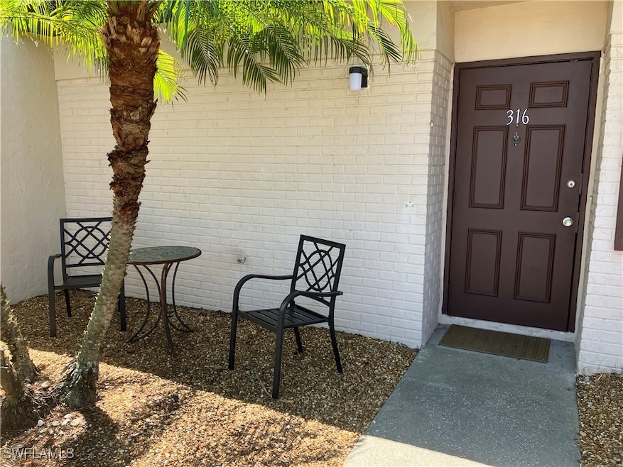 Property entrance featuring brick siding