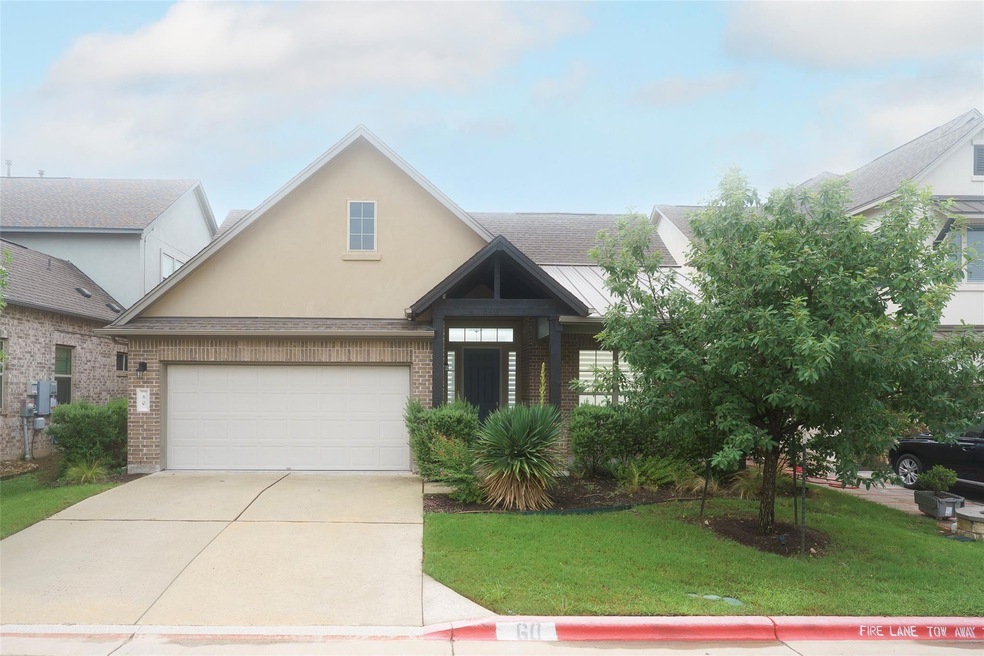 View of front facade with a garage, brick siding,