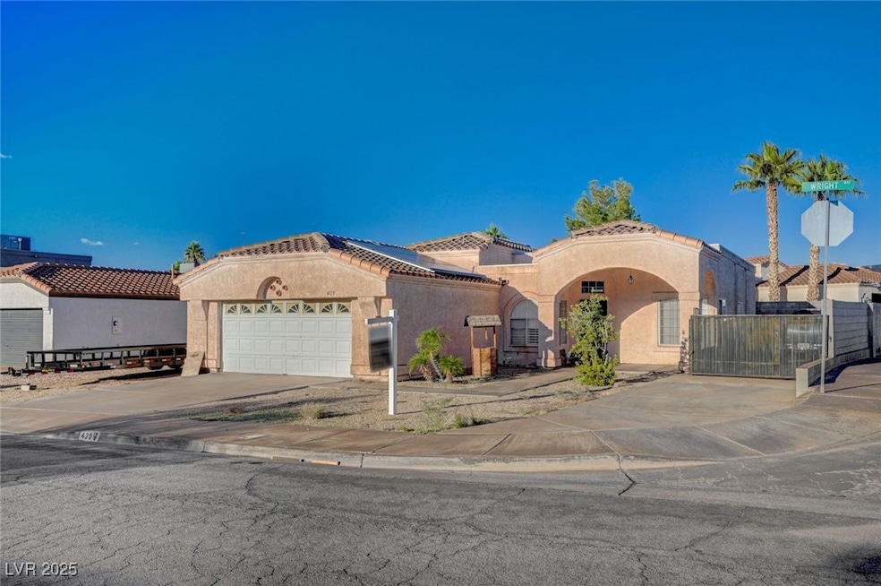 Mediterranean / spanish-style house featuring driveway, stucco siding, solar panels, and an attached garage