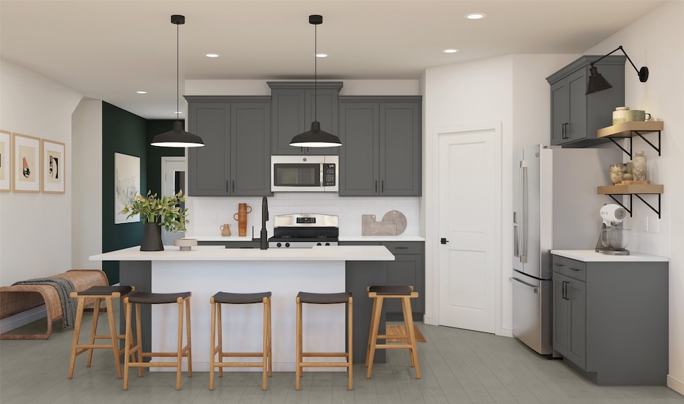 Lovely island kitchen with grey cabinets and quart
