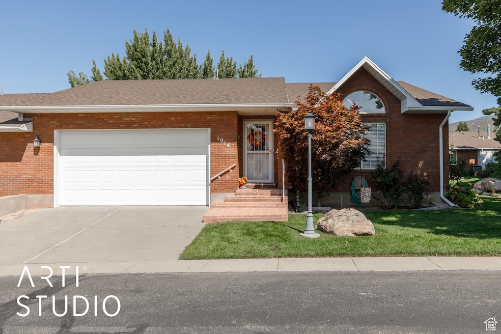 Ranch-style home featuring a shingled roof, brick siding, concrete driveway, and a garage