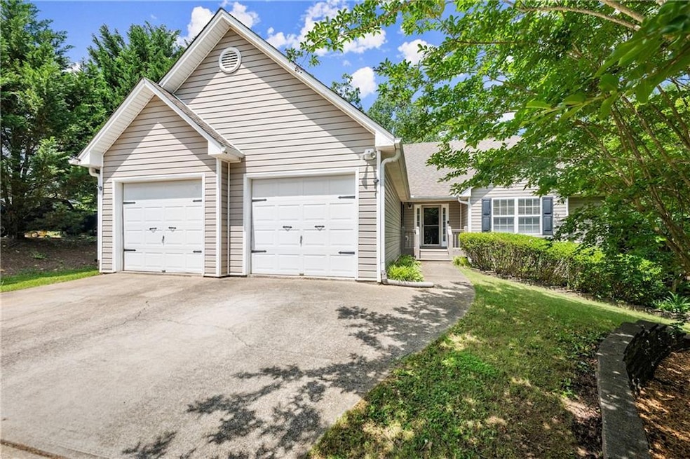 Ranch-style home featuring driveway and an attached garage