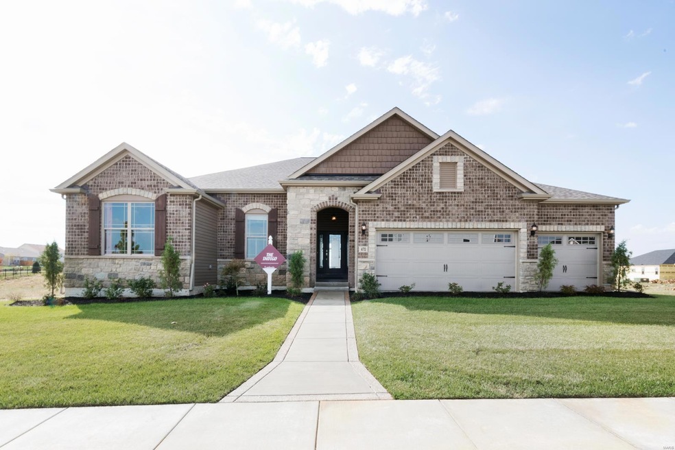 Impressive brick and stone elevation with a wide walkway to the covered entry and a 3-car garage!