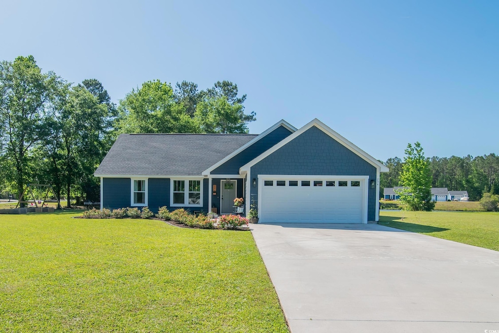 View of front of property with driveway, a front y