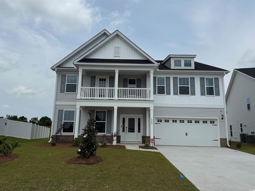 View of front of property with a balcony, driveway