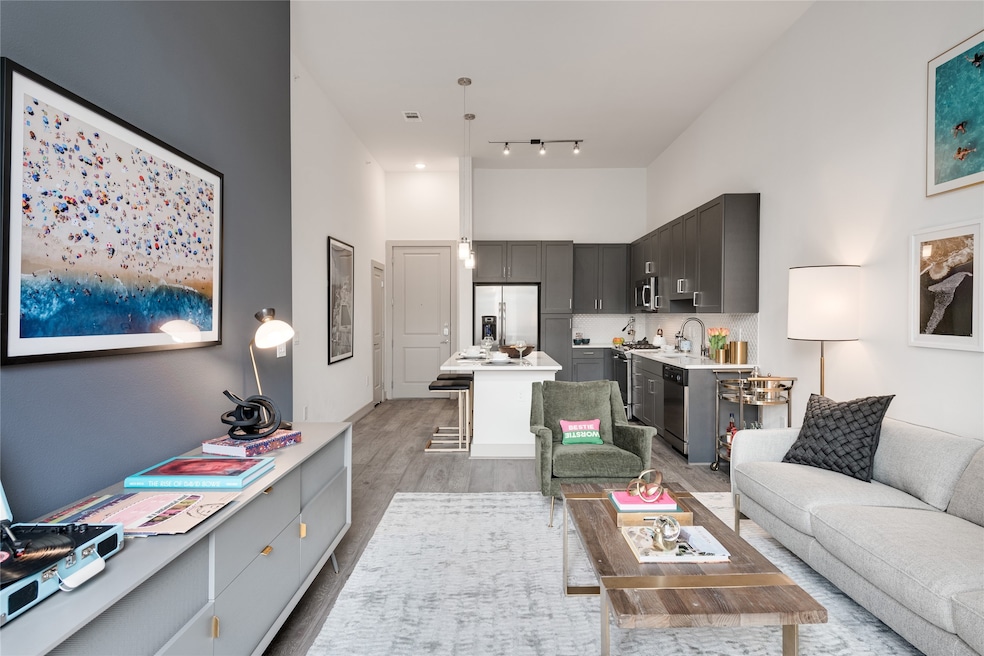 High ceilings and large windows visually expand this generous one bedroom plan.. Photos are of a this plan!