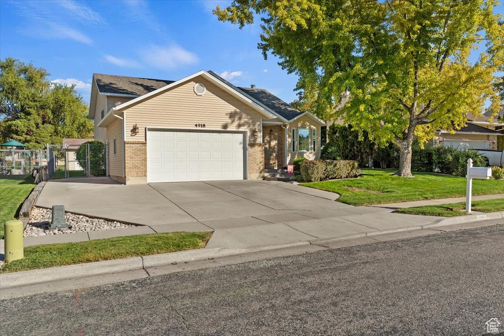 View of front of home with concrete driveway, an attached garage, and brick siding