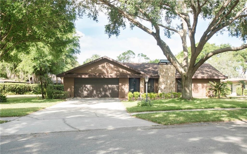 Manicured lawn, filtered shaded home with a large 