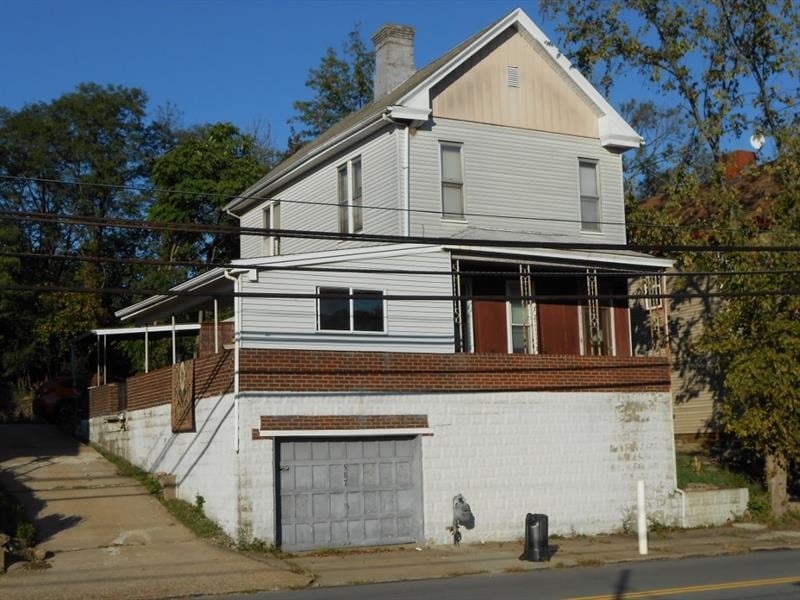 Two car tandem garage, concrete driveway.
