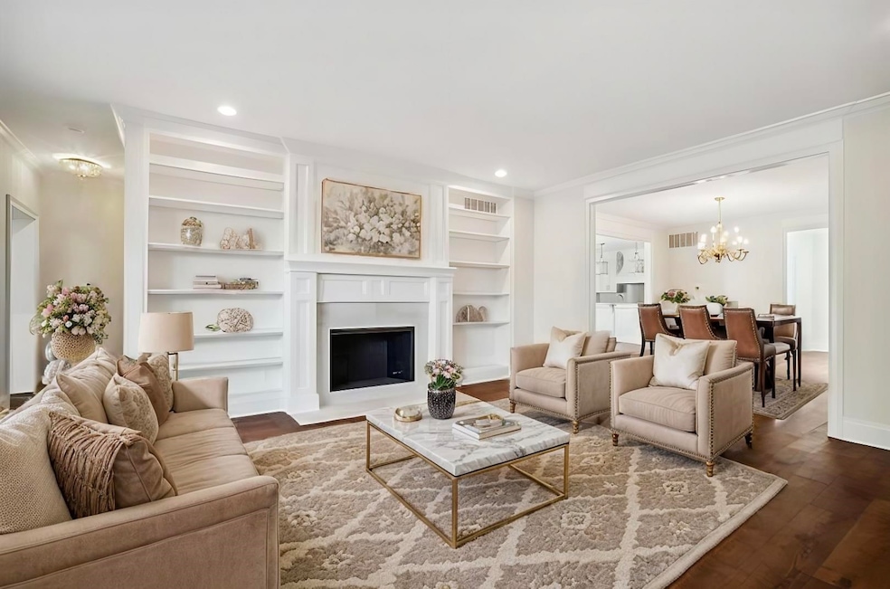 Living room with ornamental molding, a chandelier,
