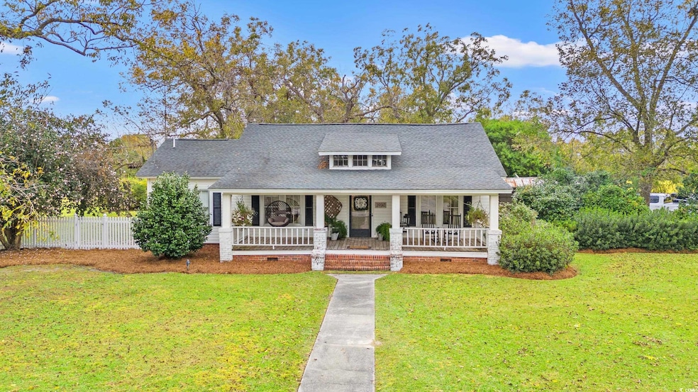 View of front of home featuring covered porch, crawl space, and a shingled roof