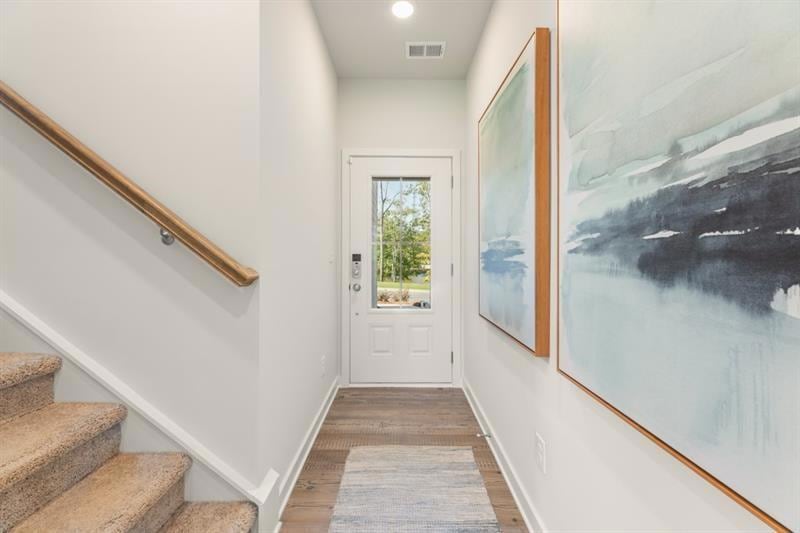 Doorway featuring stairway, wood finished floors, and recessed lighting