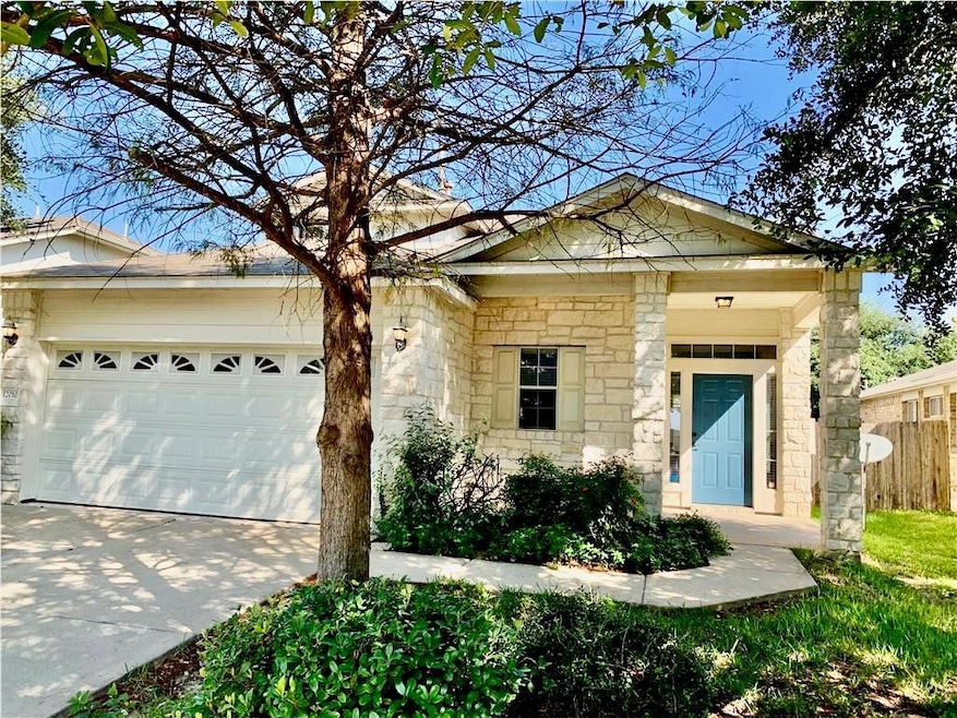 View of front of home with stone siding, driveway