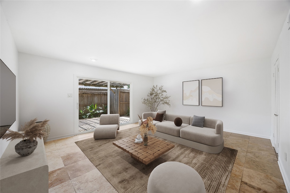 This bright living room features a modern, neutral