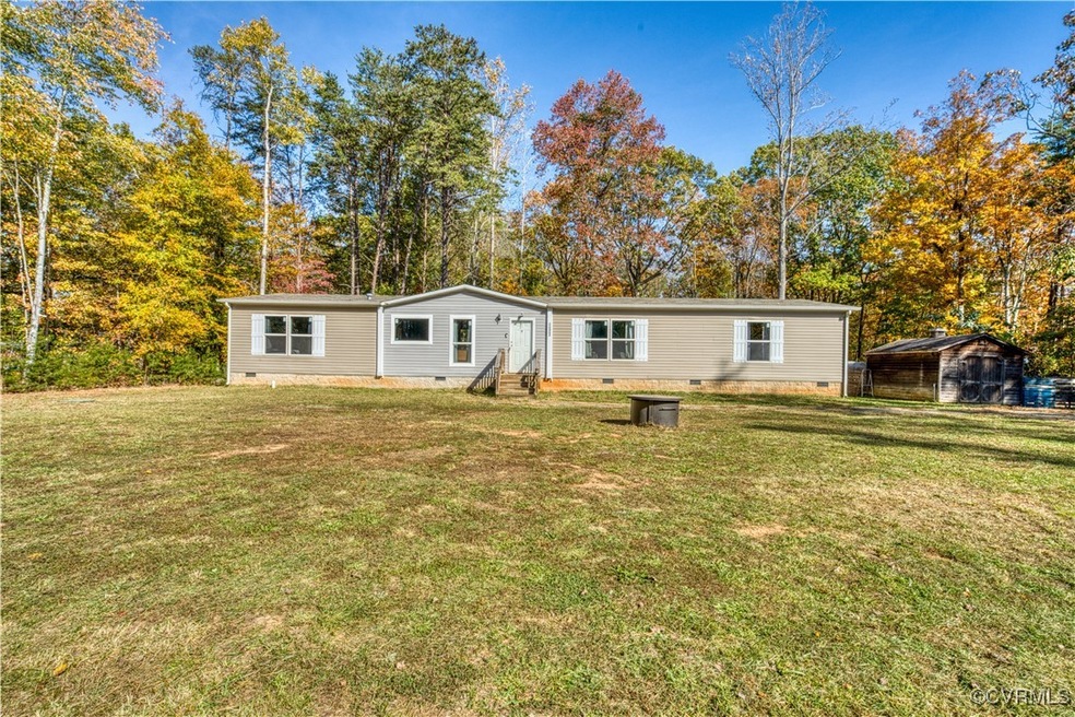 Rear view of house featuring a lawn