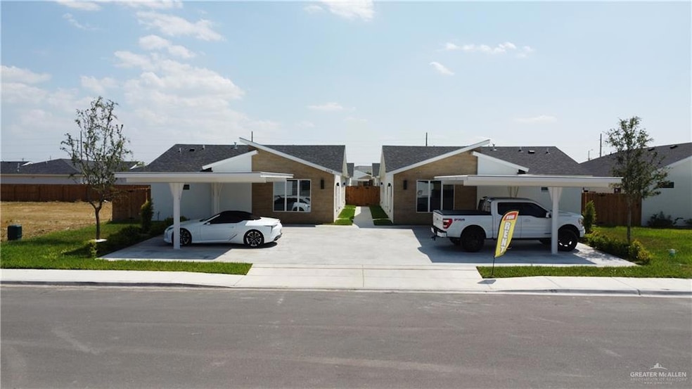 View of front facade featuring concrete driveway and an attached carport