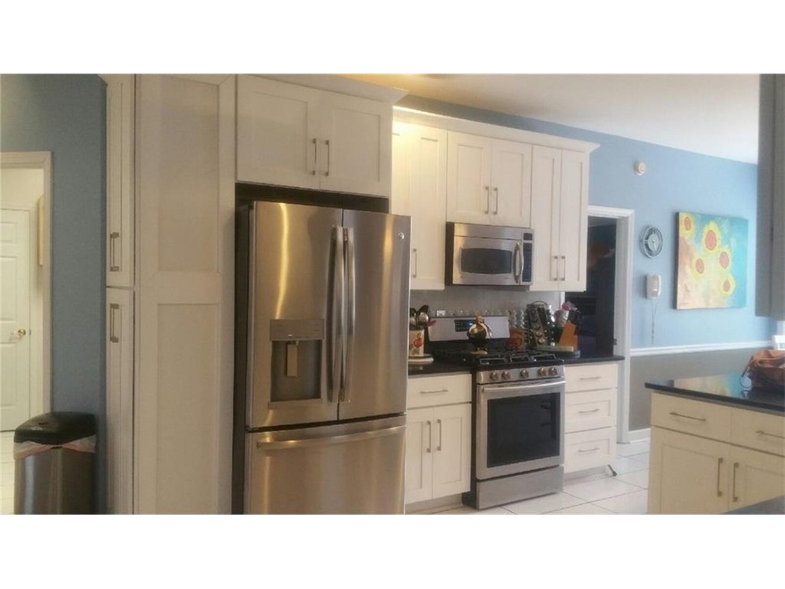 Extra pantry cabinet beside refrigerator, great for brooms, etc.