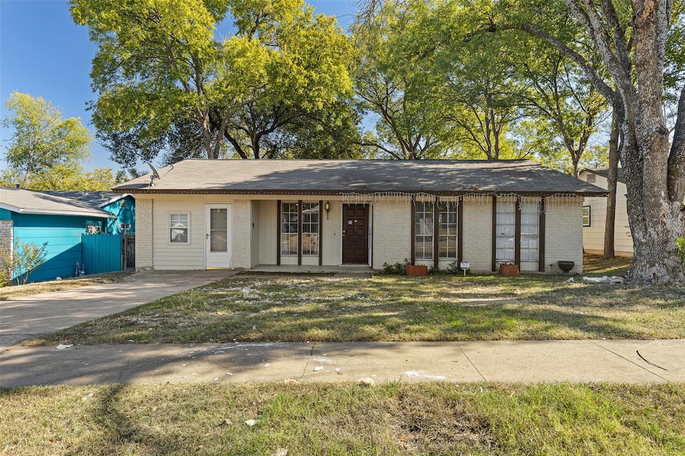 View of front of house with brick siding, a porch, and a front lawn