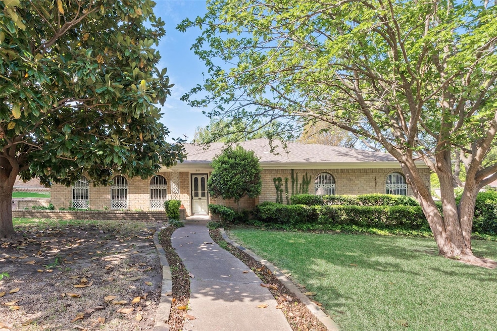 Ranch-style home with brick siding and a front law