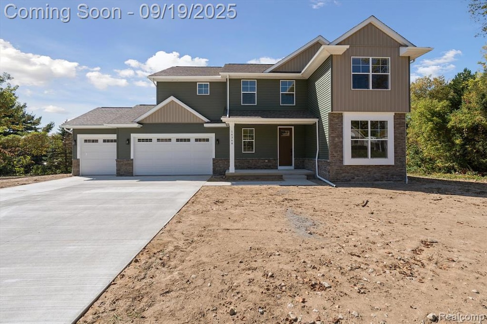 Craftsman house with covered porch, stone siding, concrete driveway, and a garage