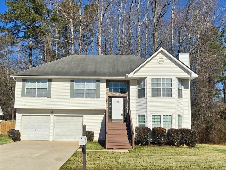Bi-level home with a front lawn and a garage