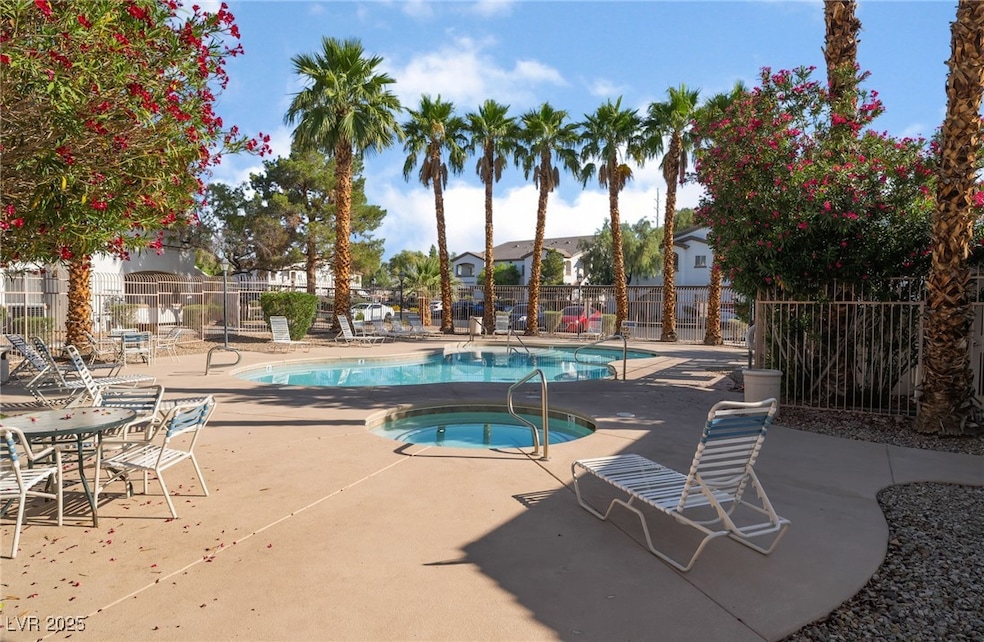 Community pool with a community hot tub and a pati