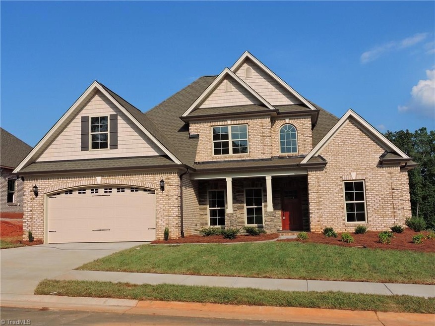 Four sided brick with stone accents on front