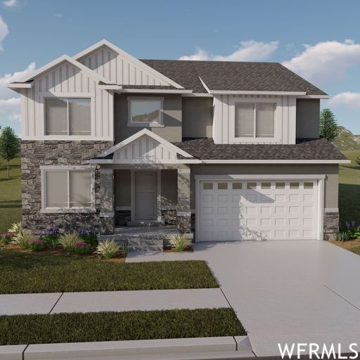 View of front of property with garage and a front yard