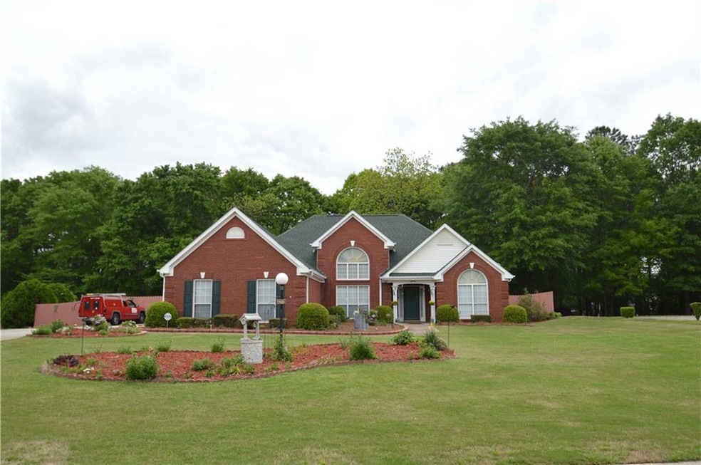 Front of home showing beautiful landscaped yard.