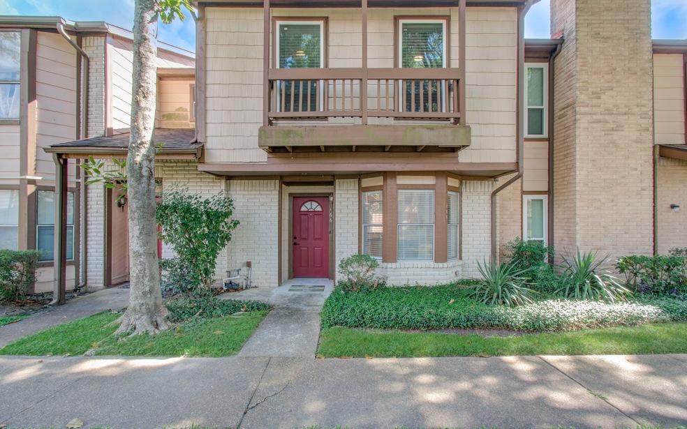 This is a two-story townhouse featuring a brick an