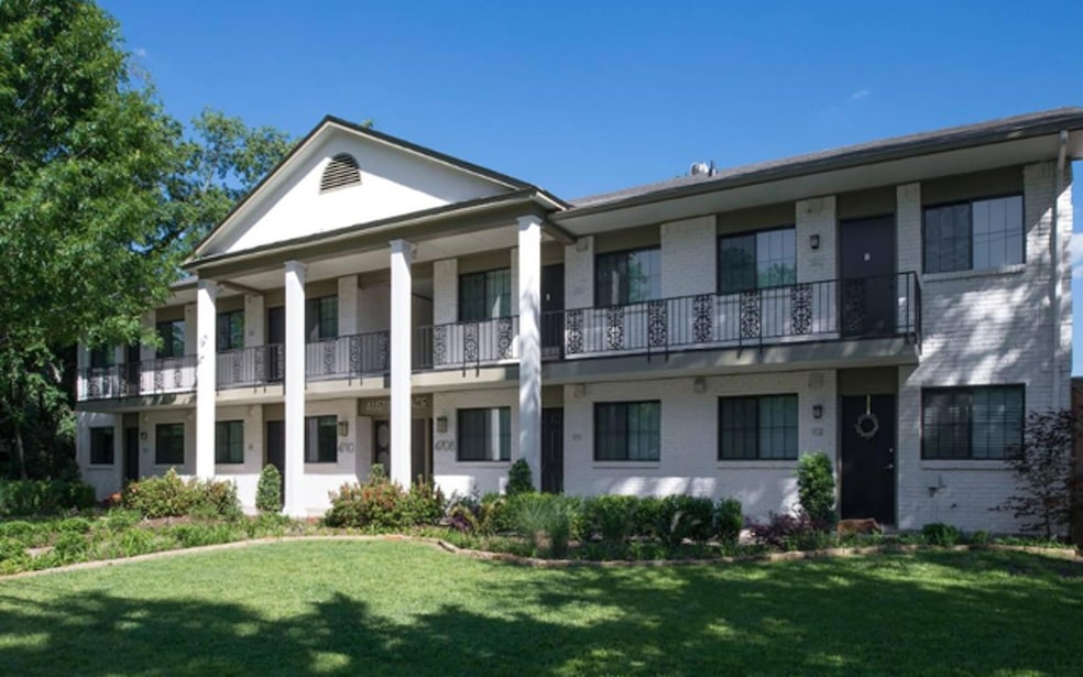 View of front of house featuring a balcony and a f