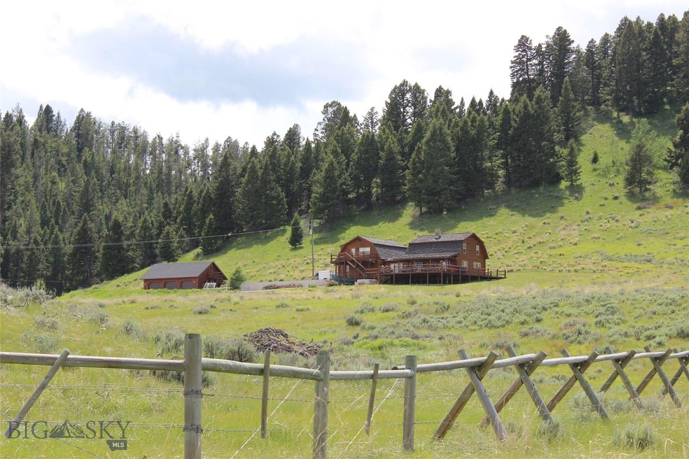 The house and 3-car garage, from road below.  Lot